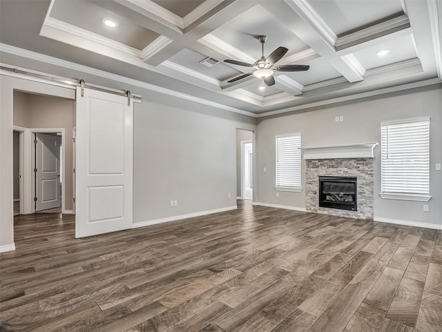 unfurnished living room featuring dark hardwood / wood-style floors, a barn door, a wealth of natural light, and coffered ceiling