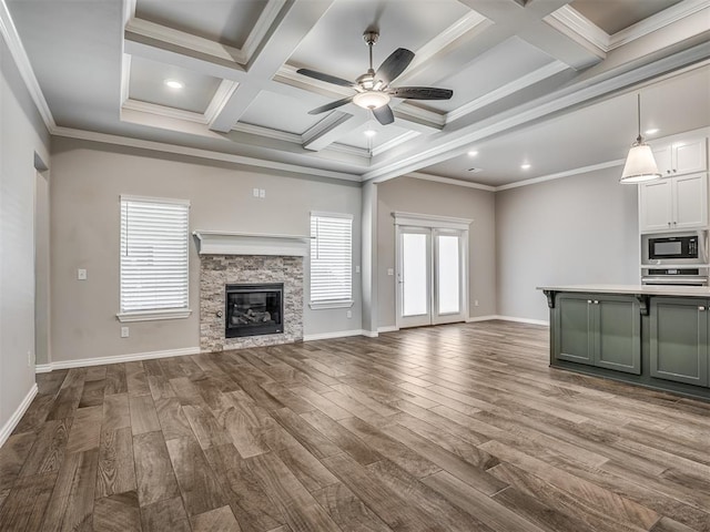 unfurnished living room with crown molding, hardwood / wood-style floors, beamed ceiling, and coffered ceiling