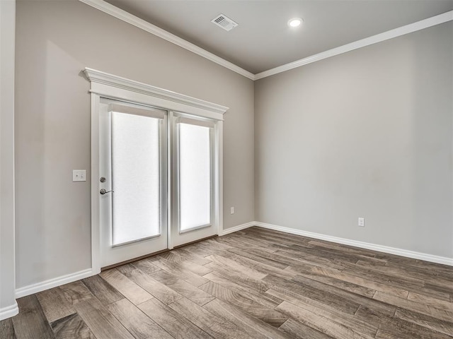 unfurnished room with hardwood / wood-style floors and ornamental molding