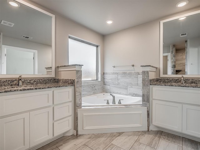 bathroom with vanity and a bathtub