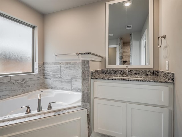 bathroom featuring vanity and a bathtub