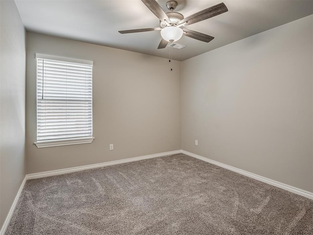 empty room featuring carpet flooring and ceiling fan