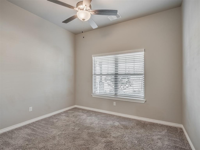 empty room featuring carpet flooring and ceiling fan