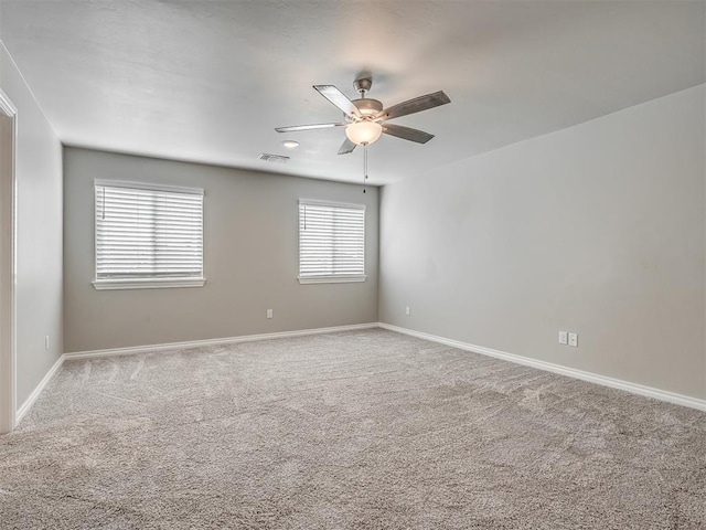 carpeted empty room featuring plenty of natural light and ceiling fan