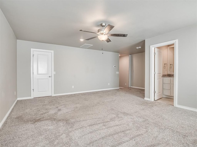 empty room featuring ceiling fan and light carpet