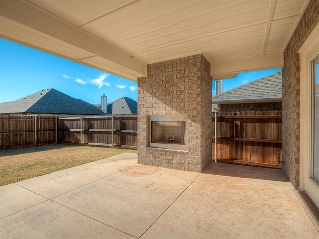 view of patio featuring an outdoor brick fireplace