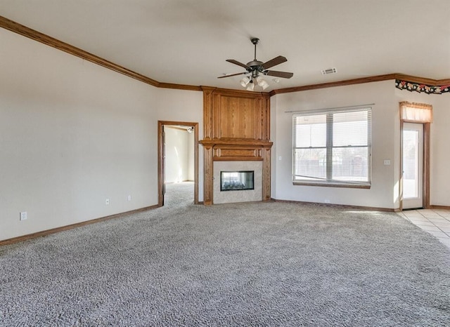 unfurnished living room featuring a large fireplace, light colored carpet, ceiling fan, and crown molding