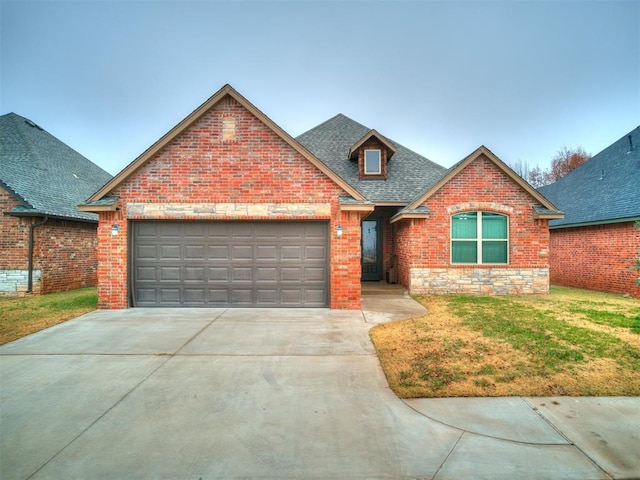 view of property with a garage and a front lawn