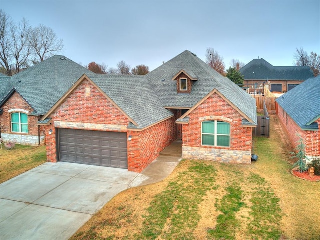 view of front of property featuring a garage and a front yard