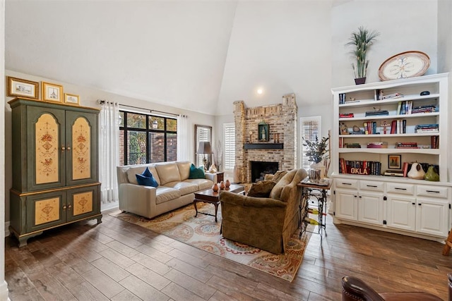 living room with a fireplace, dark hardwood / wood-style flooring, and high vaulted ceiling