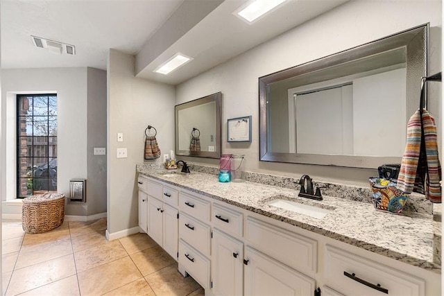 bathroom featuring tile patterned flooring and vanity