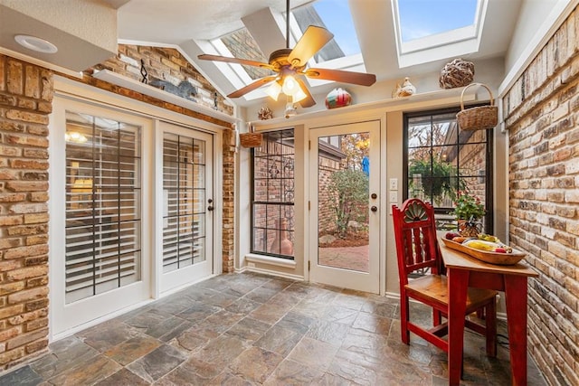 sunroom / solarium featuring ceiling fan and lofted ceiling with skylight