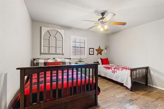 bedroom with hardwood / wood-style floors and ceiling fan