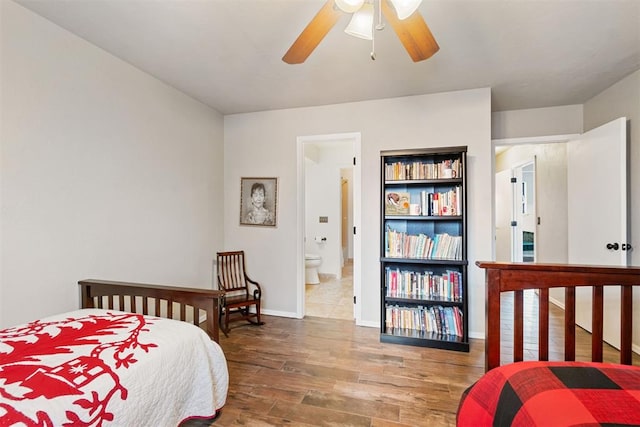 bedroom with ensuite bath, ceiling fan, and hardwood / wood-style floors