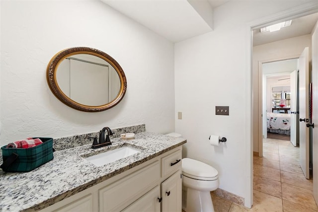 bathroom featuring tile patterned floors, vanity, and toilet