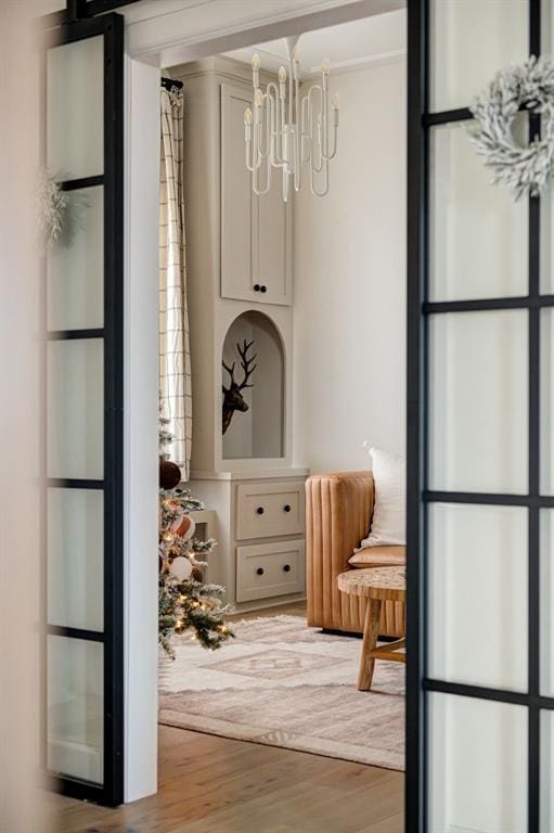 interior space featuring an inviting chandelier and light hardwood / wood-style floors