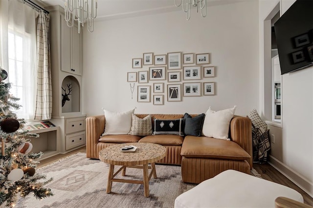 sitting room with a notable chandelier and hardwood / wood-style flooring