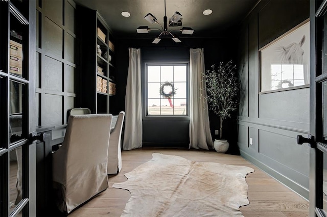 office space featuring light hardwood / wood-style floors, french doors, and a chandelier