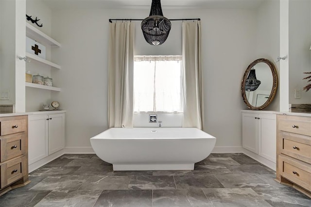 bathroom featuring vanity and a bath