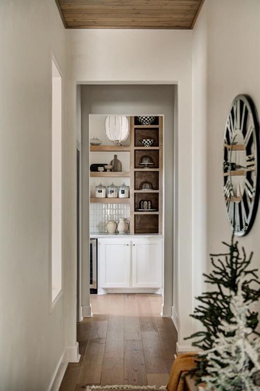 corridor featuring wood ceiling, wine cooler, and light hardwood / wood-style floors