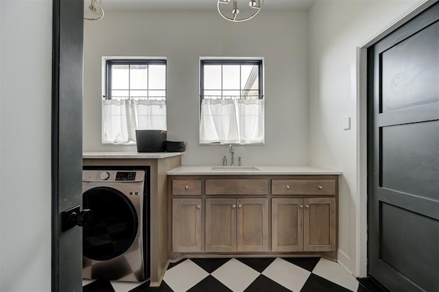 clothes washing area with washer / clothes dryer and sink