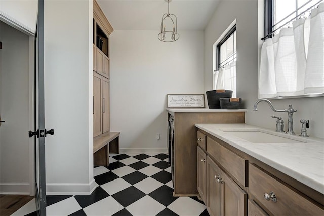 laundry room featuring sink and cabinets