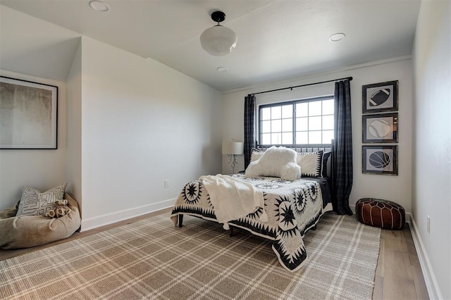 bedroom with wood-type flooring