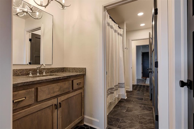 bathroom with vanity and an inviting chandelier