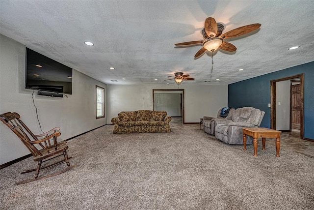 carpeted living room with ceiling fan and a textured ceiling