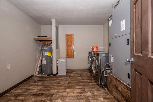 clothes washing area with washing machine and clothes dryer, heating unit, water heater, and dark wood-type flooring