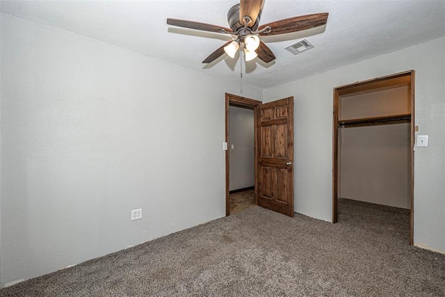 unfurnished bedroom featuring ceiling fan, a closet, and light colored carpet