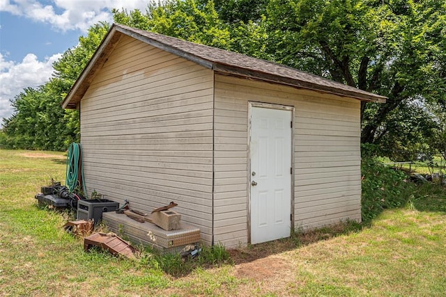 view of outbuilding featuring a yard