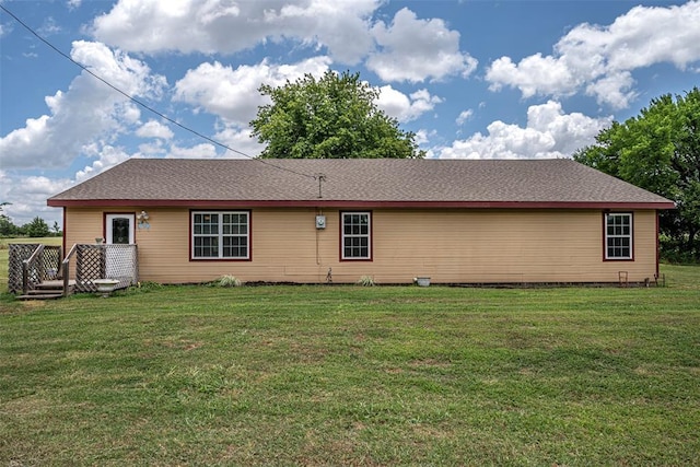 rear view of house with a yard and a deck