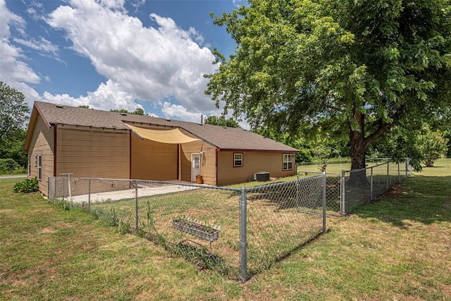 back of house featuring a yard and cooling unit