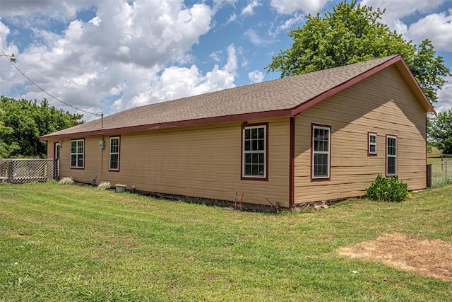 view of side of property with a yard