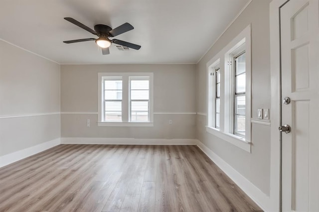 spare room with light wood-type flooring, ceiling fan, and ornamental molding