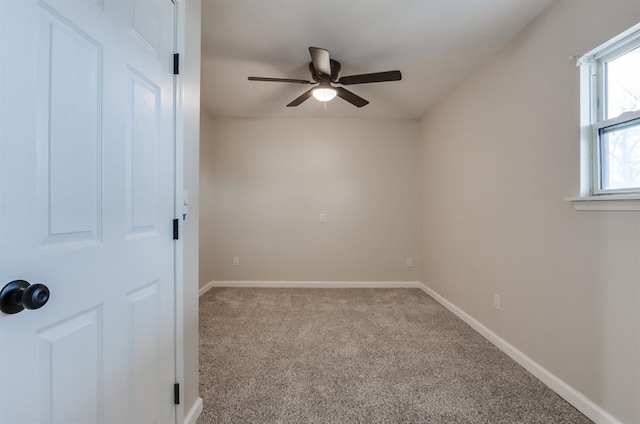 spare room featuring ceiling fan and light carpet