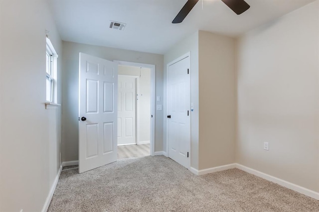 carpeted spare room with ceiling fan