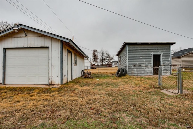 exterior space with a garage, a lawn, and an outdoor structure