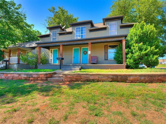 view of front of property with a front lawn and covered porch