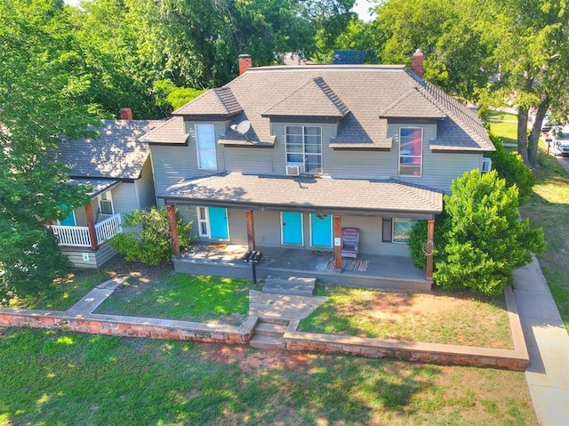 view of front of property with covered porch and a front yard