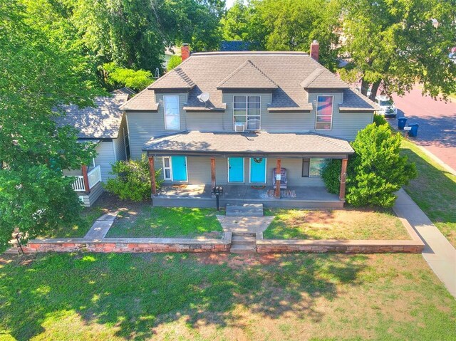 view of front of home with covered porch and a front yard