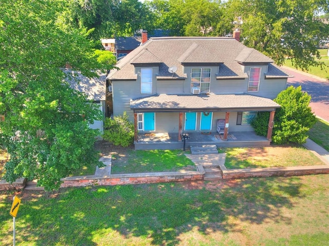 view of front of home featuring covered porch and a front yard