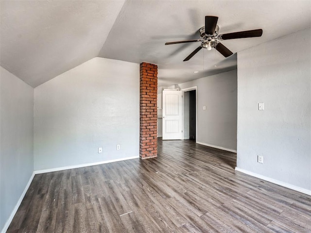 interior space with vaulted ceiling, ceiling fan, and dark wood-type flooring