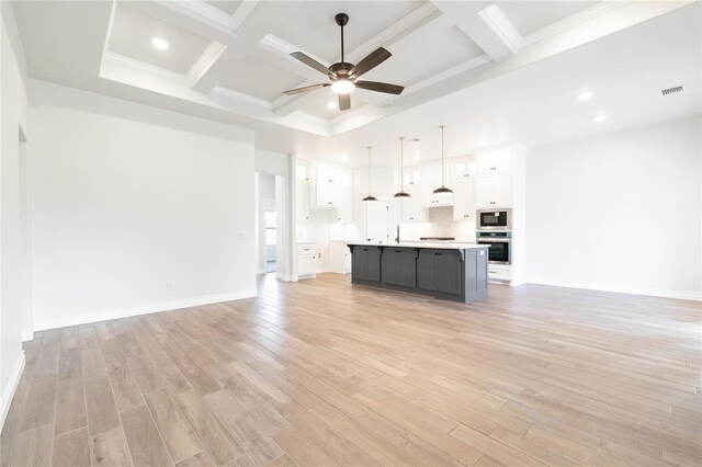 1817 Taines Turn, Norman, OK 73072 - unfurnished living room with ceiling fan, beamed ceiling, light wood-style floors, coffered ceiling, and recessed lighting