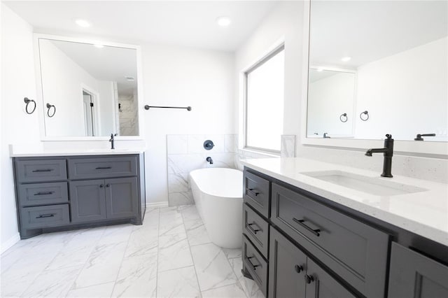 1817 Taines Turn, Norman, OK 73072 - full bathroom featuring a freestanding tub, marble finish flooring, two vanities, tiled shower, and recessed lighting
