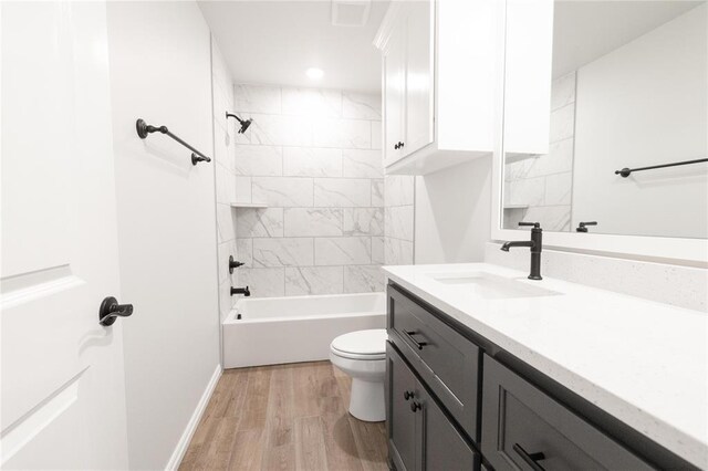 1817 Taines Turn, Norman, OK 73072 - full bath featuring toilet, wood finished floors, vanity, baseboards, and tub / shower combination