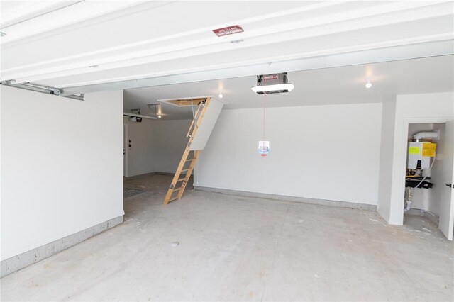 1817 Taines Turn, Norman, OK 73072 - garage featuring a garage door opener, water heater, and baseboards