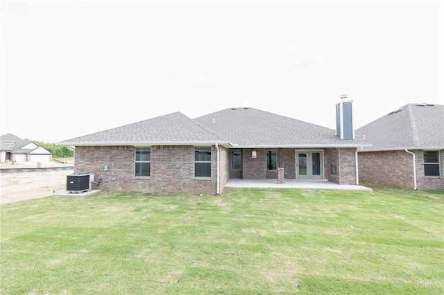 1817 Taines Turn, Norman, OK 73072 - rear view of house with central AC unit, a patio, brick siding, a chimney, and a yard