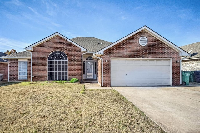 view of front facade with a front yard and a garage